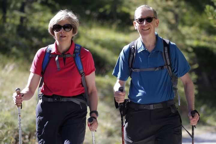 Prime Minister Theresa May walks in a forest with her husband Philip at the start of a summer holiday in the Alps in Switzerland