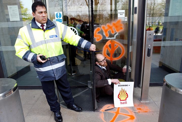 A man was seen beside graffiti at Shell's London headquarters.