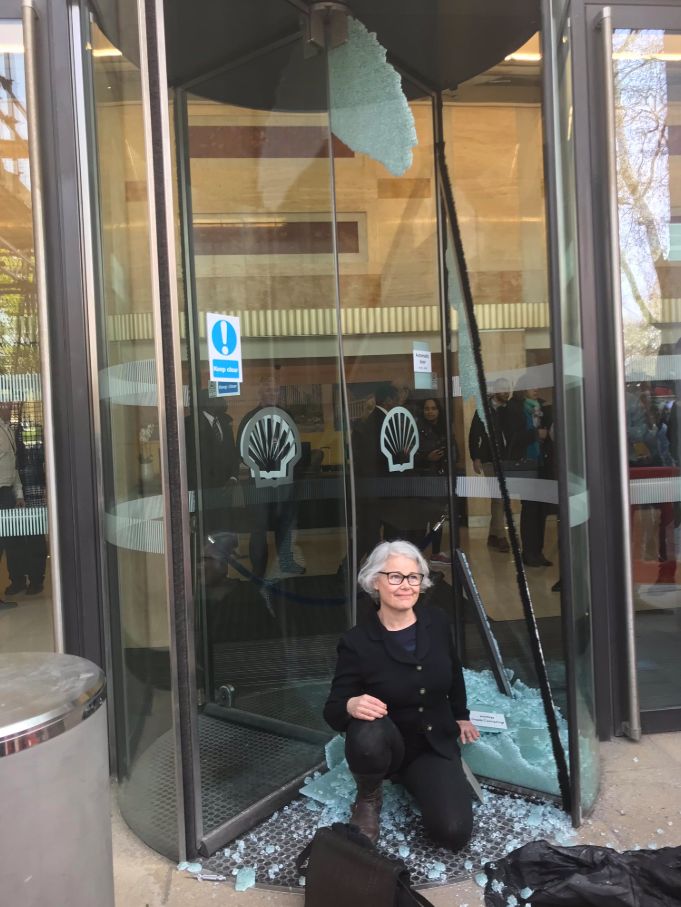 One woman sat beside a broken glass door at the London HQ of oil giant Shell.