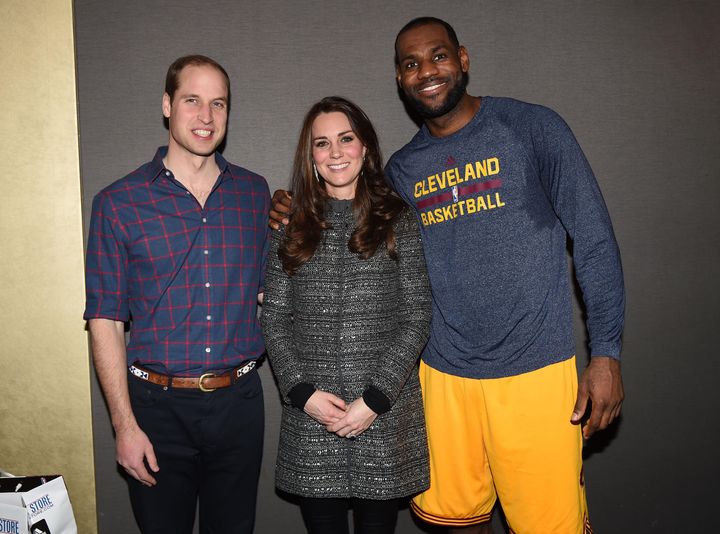 Prince William and Catherine, Duchess of Cambridge pose with LeBron James as they attend a Cleveland Cavaliers vs. Brooklyn Nets game on Dec. 8, 2014.