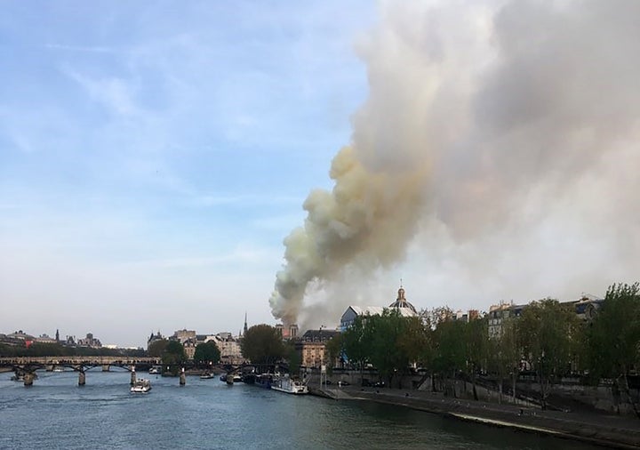 Flames and smoke are seen billowing from the roof at Notre-Dame Cathedral in Paris on Monday.