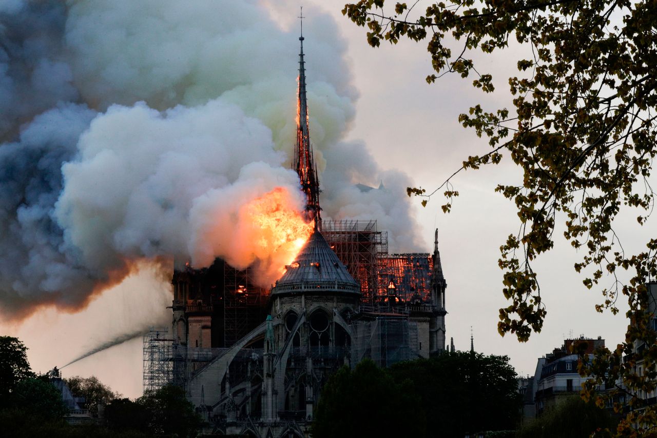Flames and smoke are seen billowing from the roof at Notre-Dame Cathedral in Paris on April 15, 2019. -