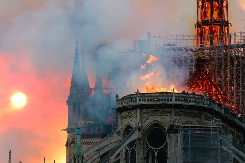 Smoke billows as flames destroy the roof of the landmark Notre Dame Cathedral in central Paris on April 15, 2019.