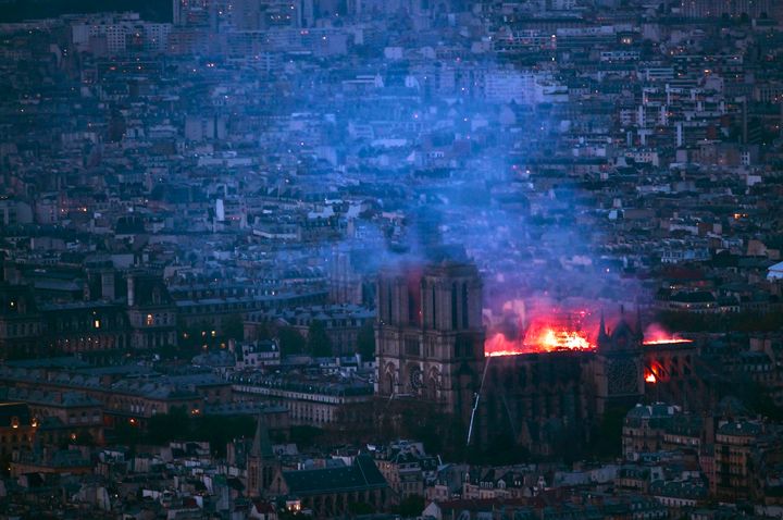 A view from Montparnasse Tower shows flames and smoke billowing from the roof of Notre Dame Cathedral in Paris.