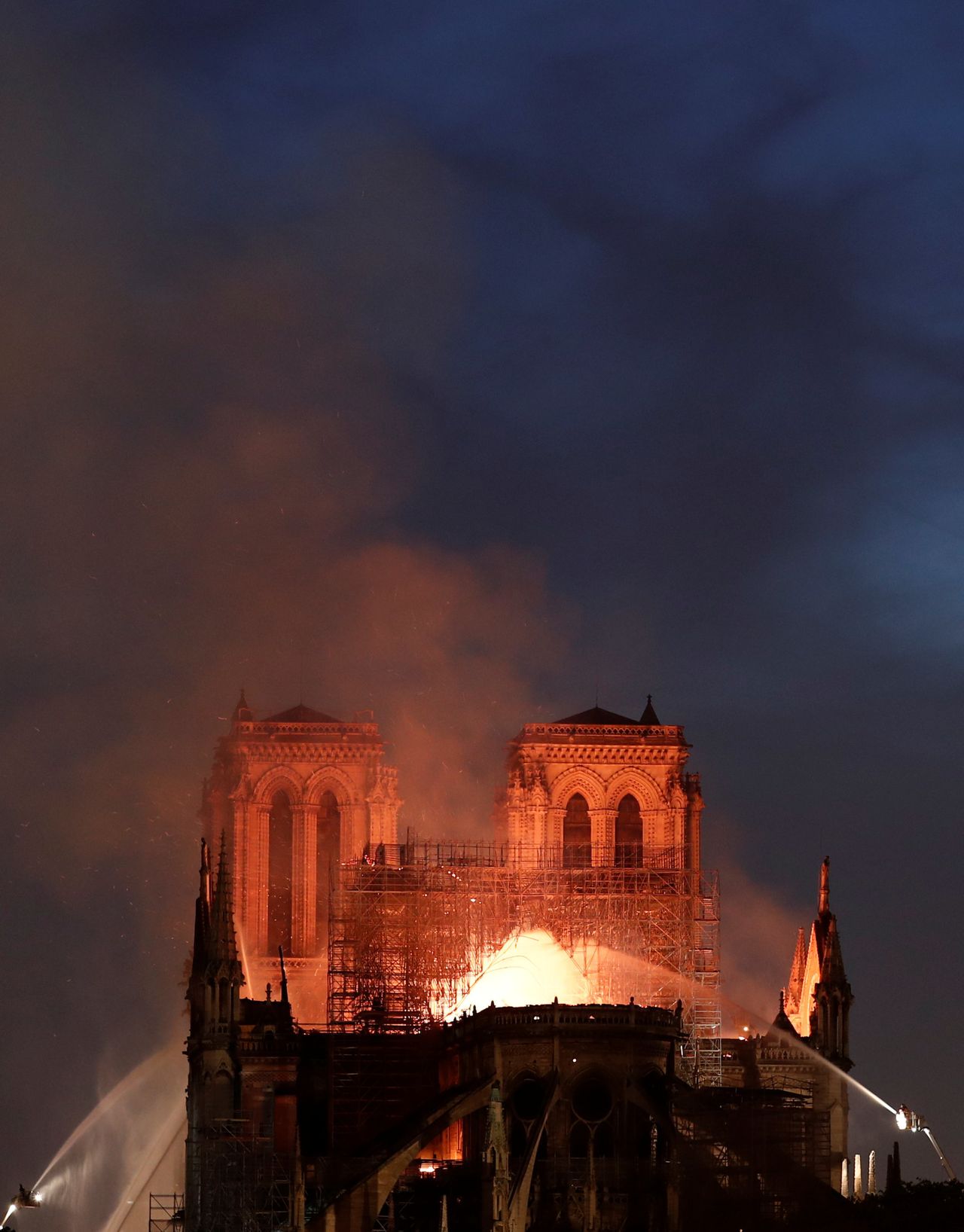 Flames engulf the roof at Notre Dame cathedral as firefighters battle to extinguish the fire on Monday night.