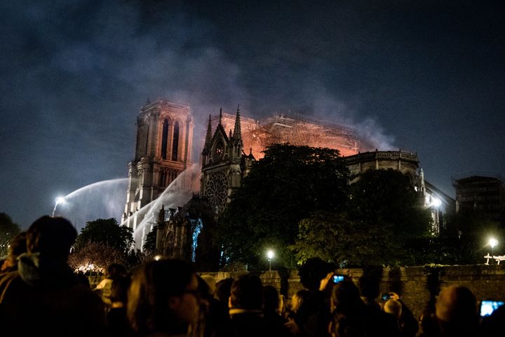Hundreds of firefighters worked to put out the fire that enveloped Notre Dame cathedral in Paris on Monday. The blaze was <a 