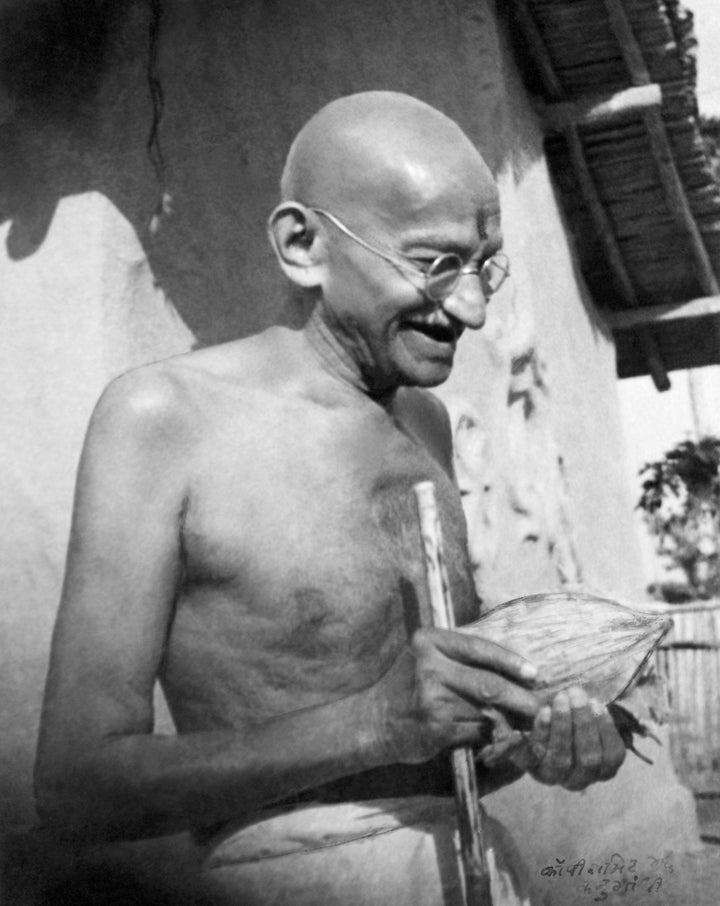 Gandhi, who was known to love fruit, receives a coconut in front of his hut at Sevagram Ashram in January 1942.