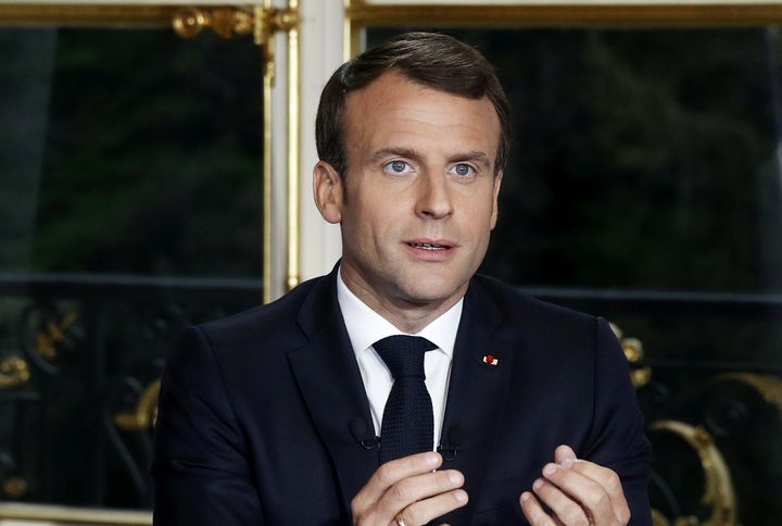 French President Emmanuel Macron gestures while addressing the French nation following a massive fire at Notre Dame Cathedral, at the Elysee Palace in Paris.
