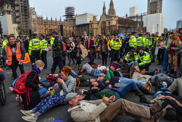 Climate change protesters lay down in the road in front of the Houses of Parliament in London.