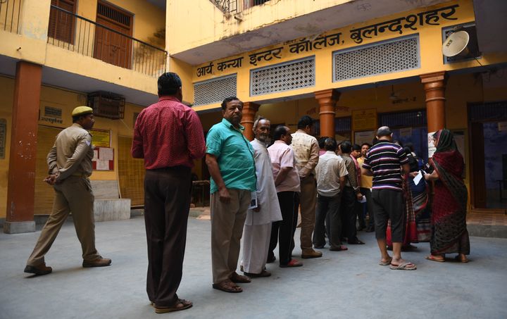 Voters queue up to cast their vote at a polling station in Bulandshahr, Uttar Pradesh on 18 April 2019, in the second phase of the Lok Sabha election. 