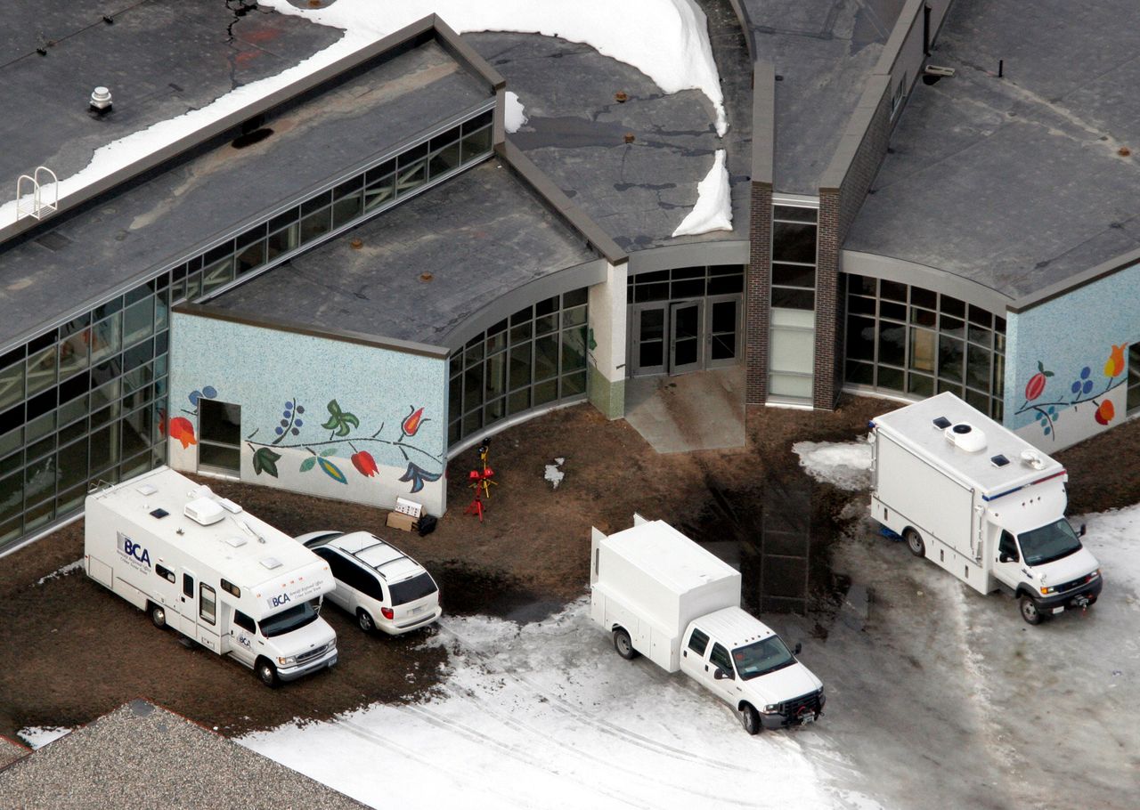 Police forensic vans sit outside of Red Lake Senior High School the day after the shooting.