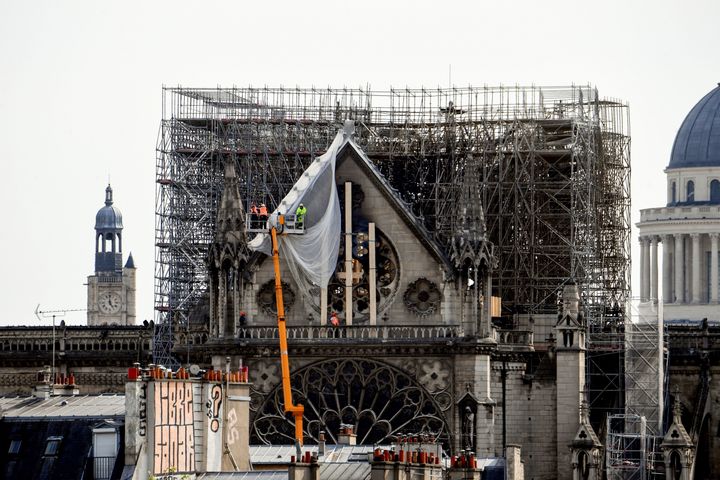 The cathedral's iconic steeple, and portions of its walls and roof, were destroyed in Monday's fire.