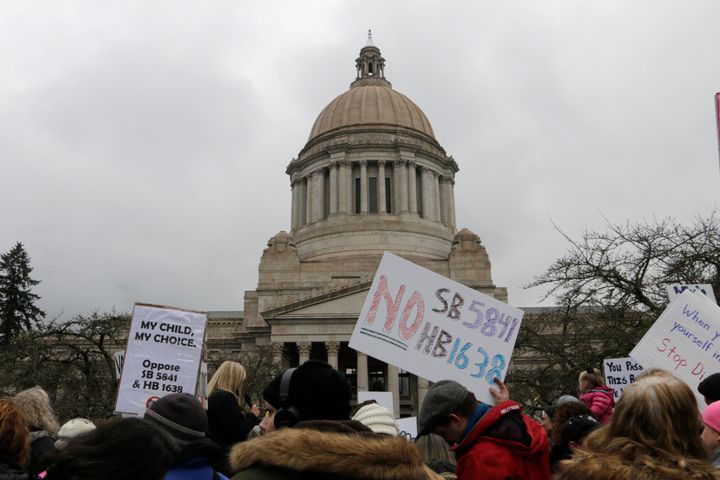 Opponents to efforts to remove philosophical exemptions from school vaccine requirements rally outside the Washington Capitol in Olympia in February.