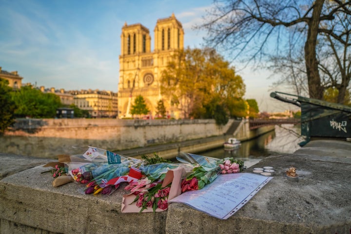 Flowers are placed in front of Notre Dame Cathedral on April 18, 2019 in Paris, France.&nbsp;