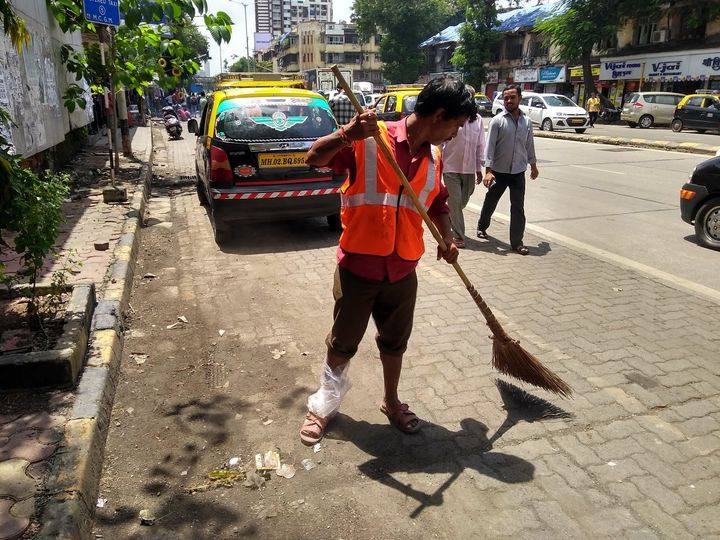 Ganesh Shinde at work, with his injured foot wrapped in plastic.