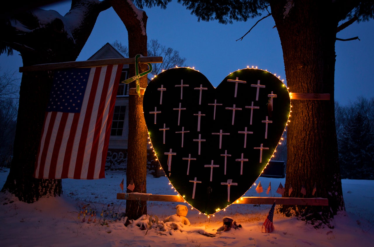 A memorial bearing 26 crosses for each victim on the one-year anniversary of the massacre.