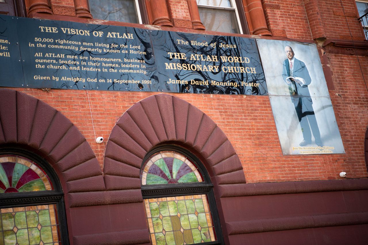 The exterior of Atlah World Missionary Church features a large portrait of Manning.