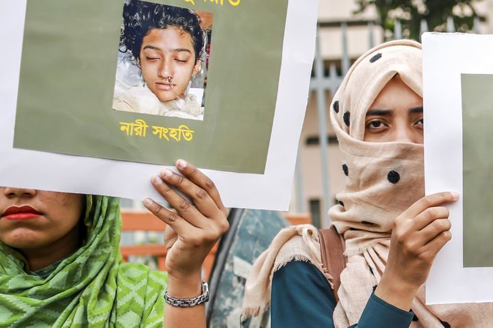 In this photo taken on April 12, 2019, Bangladeshi women hold placards and photographs of Nusrat Jahan Rafi at a protest in Dhaka, following her murder by being set on fire after she had reported a sexual assault.