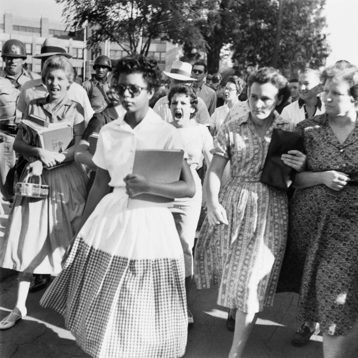 Elizabeth Eckford, one of the group of nine black students known as Little Rock Nine, walks to Little Rock's Central High with an angry mob surrounding her.