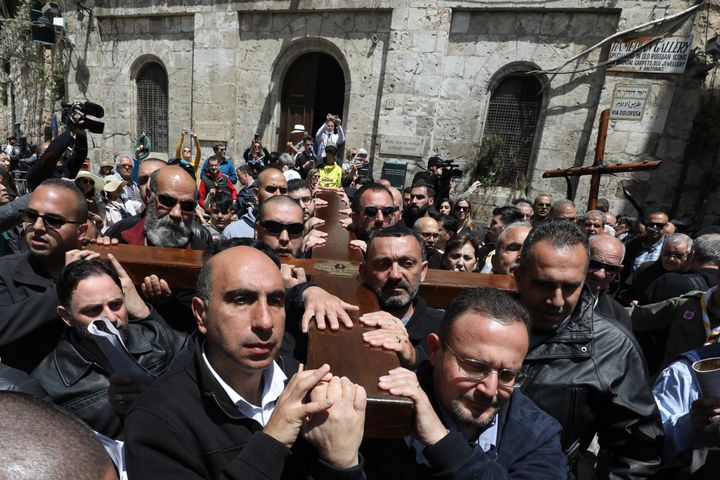 Members of a local Catholic Palestinian parish carry a wooden cross along the Via Dolorosa (Way of Suffering) in Jerusalem's Old City on Good Friday.
