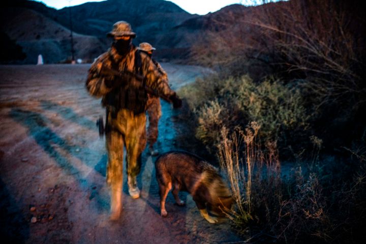 "Viper" and "Stinger" — armed members of the Constitutional Patriots New Mexico Border Ops Team militia — patrol the border last month in Sunland Park, New Mexico.
