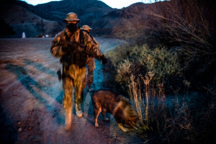 "Viper" and "Stinger" — armed members of the Constitutional Patriots New Mexico Border Ops Team militia — patrol the border last month in Sunland Park, New Mexico.