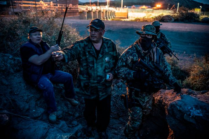 United Constitutional Patriots members Jeff Allen, Jim Benvie, "Viper" and "Stinger" take a cigarette break while patrolling the U.S.-Mexico border in Sunland Park, New Mexico, last month.