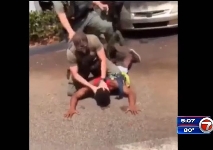 An officer is seen bashing the teenager's head against the concrete before hitting the teen in the head.