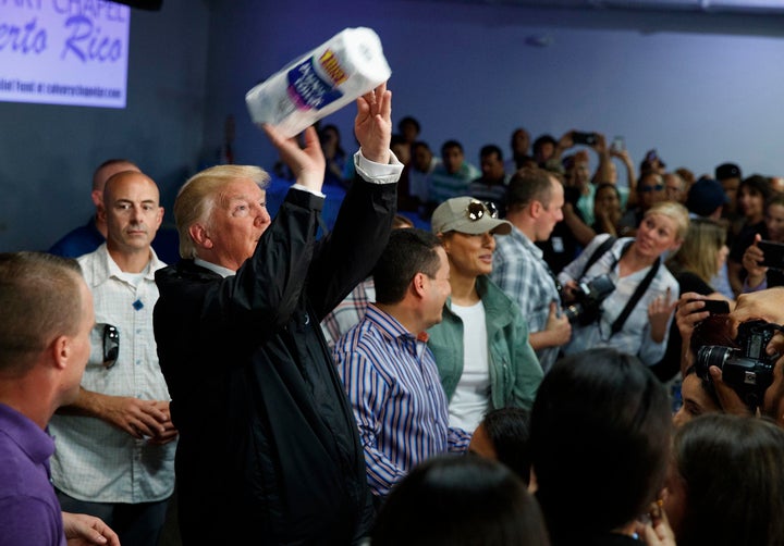 President Donald Trump tosses paper towels into a crowd at Calvary Chapel in Guaynabo, Puerto Rico, on Oct. 3, 2017, after Hurricane Maria devastated the region.