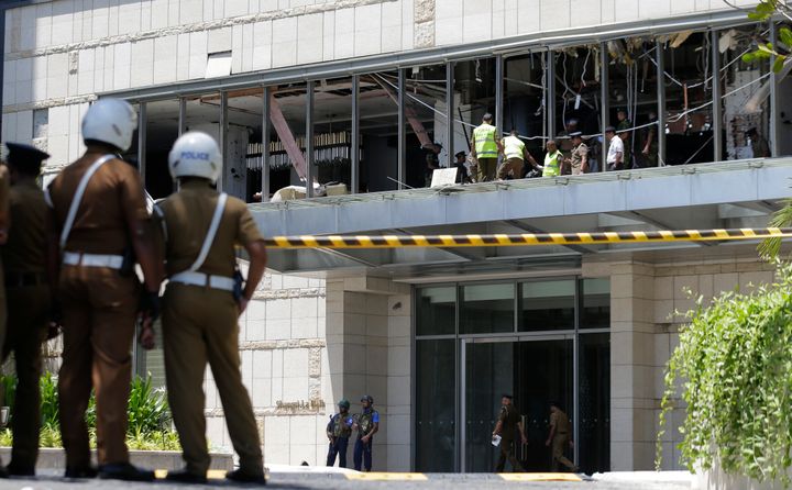 Police and forensic officials inspect a blast spot at the Shangri-la hotel in Colombo, Sri Lanka, Sunday, April 21, 2019.