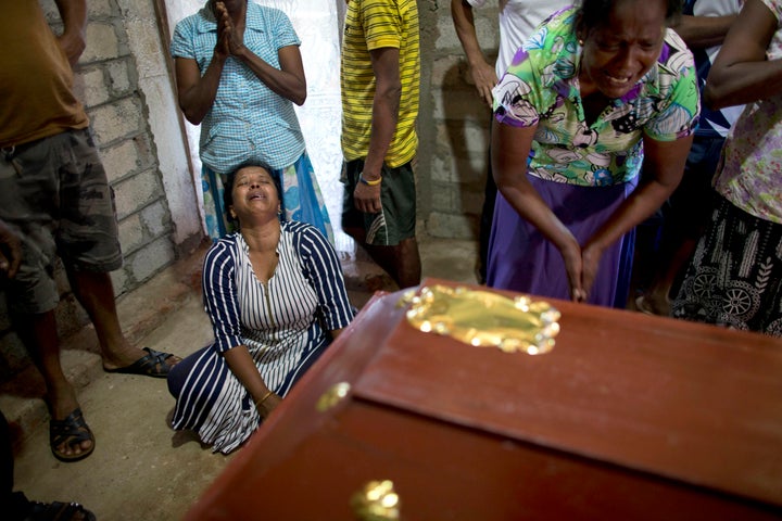 Relatives cry near the coffin for 12-year Sneha Savindi, who was a victim of Easter Sunday bombing at St. Sebastian Church.