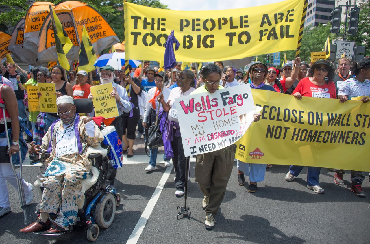 Protesters march to the Department of Justice during a rally against home foreclosures in Washington on May 20, 2013.