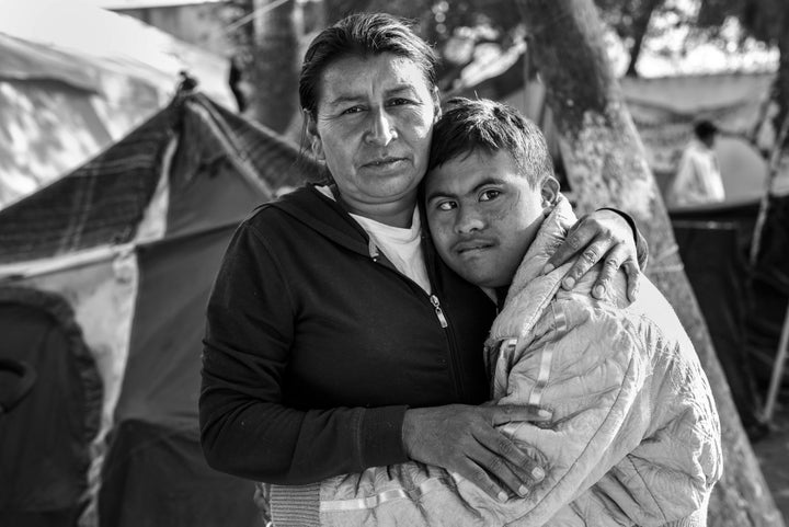 A Mother and Her Son in TijuanaJavi, who has Down syndrome, hugs his mother Maria Lucia Cardinas in the Benito Juraez shelter in Tijuana, Mexico. They left Honduras after Maria’s two brothers were murdered and their house was burned down. Maria and Javi were allowed entry into the U.S. while their asylum case is under review. They received support from the Minority Humanitarian Foundation and currently reside in San Diego, California.