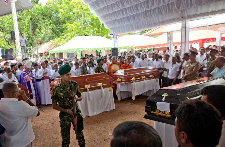 A soldier stands guard during a funeral service attended by Cardinal Malcolm Ranjith for Easter Sunday bomb blast victims at St. Sebastian Church in Negombo, Sri Lanka, on April 23, 2019. 