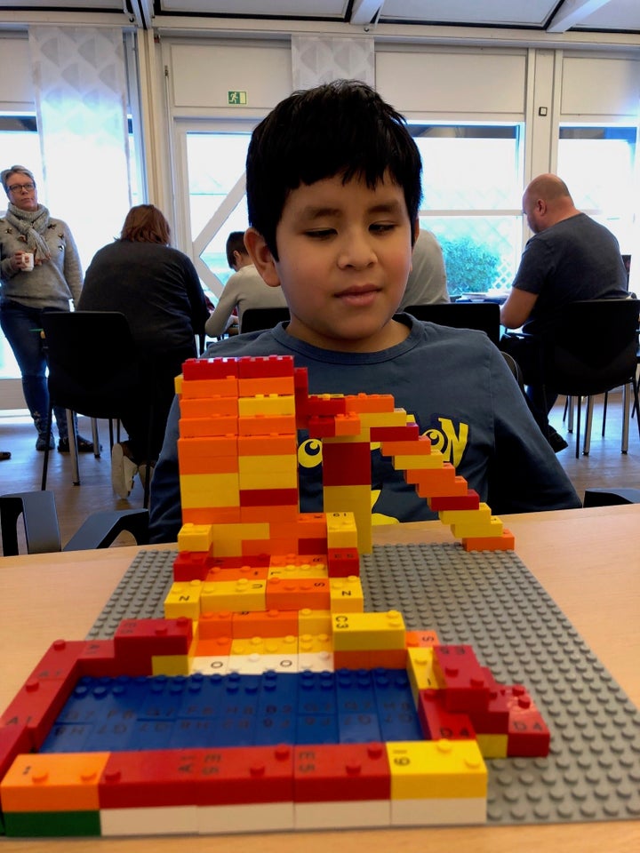 Callum using Braille bricks. 