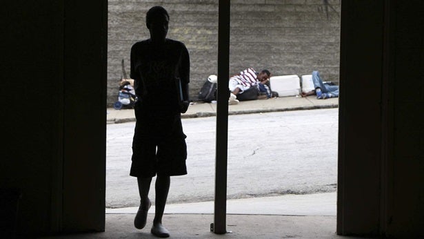 <p>A person walks into a shelter in Atlanta. Cities and counties including Atlanta are experimenting with creative ways to prevent homelessness among people who have been in jail or prison.</p>