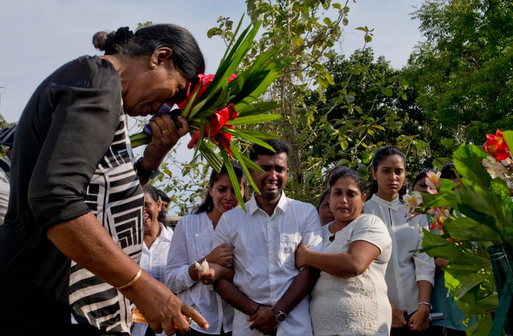 Nilanga Anthony, center, mourns the death of her seven-year-old nephew Dhulodh Anthony, on April 23, 2019 in Negombo, Sri Lanka.