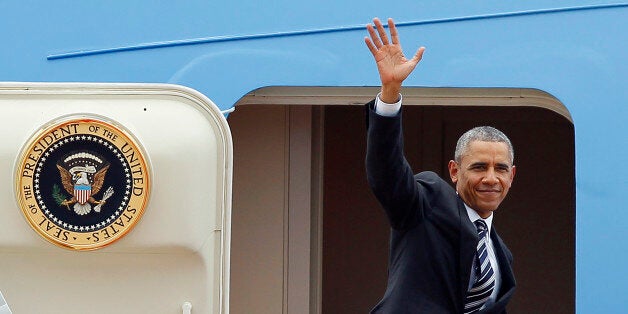 US President Barack Obama waves as he boards Air Force One upon his departure from Noi Bai international airport in Hanoi on