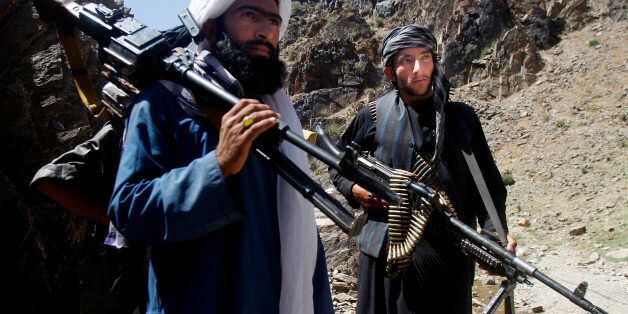 In this Friday, May 27, 2016 photo, members of a breakaway faction of the Taliban fighters prepare to guard a gathering , in Shindand district of Herat province, Afghanistan. Mullah Abdul Manan Niazi said Sunday, May 29, 2016 he was willing to hold peace talks with the Afghan government but would demand the imposition of Islamic law and the departure of all foreign forces. (AP Photo/Allauddin Khan)