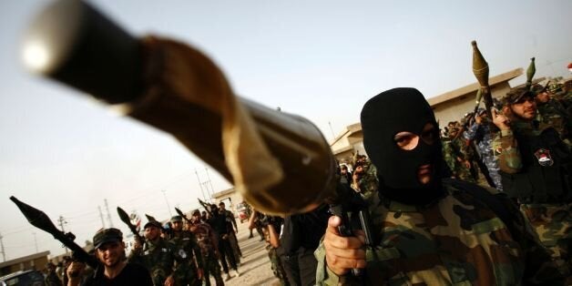 Members of the Saraya al-Salam (Peace Brigades), a group formed by Iraqi Shiite Muslim cleric Moqtada al-Sadr, march in Iraq's holy city of Najaf as they prepare to reinforce government forces in the fight against the Islamic State group for control of Fallujah, east of the capital, on May 17, 2016. Iraqi security forces and allied fighters have regained significant ground from the jihadists, securing the Ramadi area earlier this year and retaking the town of Heet last month. But parts of Anbar -- including Fallujah -- are still under IS control, as is most of Nineveh province, to its north. / AFP / HAIDAR HAMDANI (Photo credit should read HAIDAR HAMDANI/AFP/Getty Images)