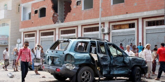 ADEN, YEMEN - MAY 23: Yemeni people inspect an incident area after a car bomb attack in Aden, Yemen on May 23, 2016. At least 30 civilians killed and 35 others were wounded in the attack, reported. (Photo by Stringer/Anadolu Agency/Getty Images)