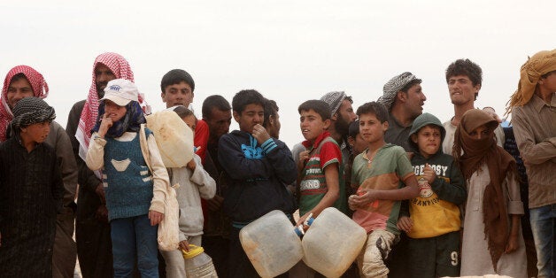 HADALAT, JORDAN - MAY 4: Syrian refugees arrive at the Jordanian military crossing point of Hadalat at the border with Syria after a long walk through the Syrian desert on May 4, 2016 in Hadalat, Jordan. Coming from the cities of Raqaa, Deir Al-Zor and Hama, roughly 300 hundred refugees crossed into Jordan at Hadalat on Wednesday, while over 5000 refugees crossed in the last four days coming from Aleppo. (Photo by Jordan Pix/ Getty Images)