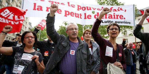 French labour union members march during a demonstration in protest of the government's proposed labour law reforms in Paris,
