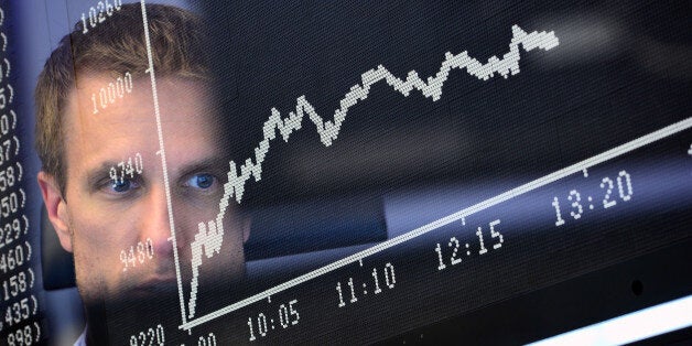 FRANKFURT AM MAIN, GERMANY - JUNE 24: (Editors Note: This picture is taken with the in-camera multiexposure mode.) Trader sit at his desk under the day's performance board that shows a dive in the value of the DAX index of companies at the Frankfurt Stock exchange the day after a majority of the British public voted for leaving the European Union on June 24, 2016 in Frankfurt am Main, Germany. Many prominent corporate CEOs and leading economists have warned that a Brexit would have strongly negative consequences for the British economy and repercussions across Europe as well. (Photo by Thomas Lohnes/Getty Images)