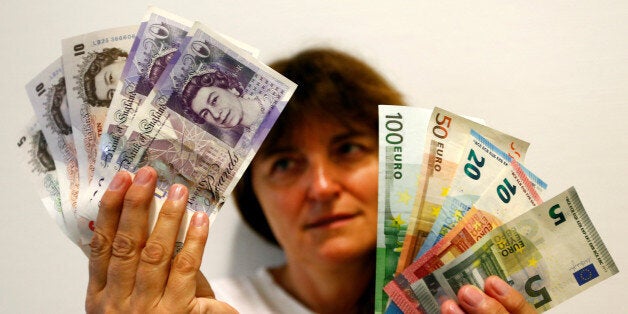 An employee holds British pounds and Euro banknotes in a bank at the main train station in Munich, Germany, June 24, 2016 after Britain voted to leave the European Union in the EU BREXIT referendum. REUTERS/Michaela Rehle