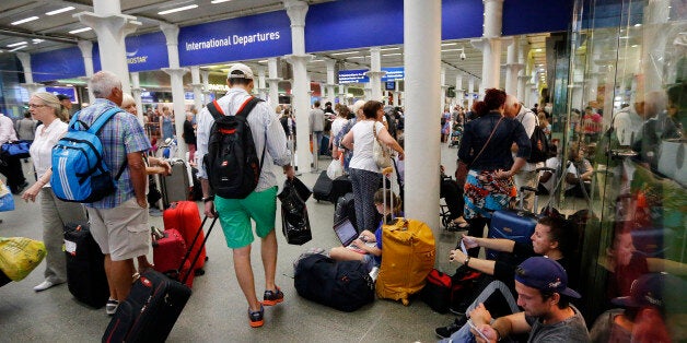 People queue as they wait at the St. Pancras international train station terminal in London, Thursday, July 2, 2015. French port workers are due to strike in Calais, France, and some disruption to the EuroStar train disruption is expected. (AP Photo/Frank Augstein)