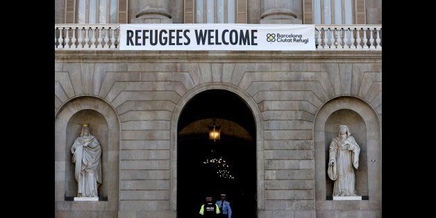 A banner reading 'Refugees Welcome' hangs on the facade of the Barcelona's City Hall, on March 18, 2016 days after Barcelona's mayor Ada Colau, Lampedusa's mayor Giusepinna Nicolini and Lesbo's mayor Spyros Galinos signed cooperation agreements to manage the crisis of refugees.Catalan regional president, Carles Puigdemont announced today his offer to Brussels to accommodate 4,500 refugees in Catalonia. / AFP / JOSEP LAGO (Photo credit should read JOSEP LAGO/AFP/Getty Images)