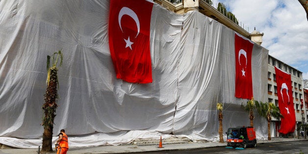 Buildings are seen covered and decorated with Turkish flags after Tuesday's car bomb attack on a police bus, in Istanbul, Tur