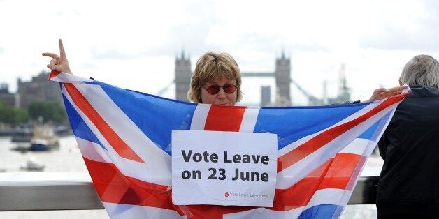 LONDON, UNITED KINGDOM - JUNE 15: A leave supporter is seen as fishing boats campaigning for Brexit sail down the Thames through central London, United Kingdom on June 15, 2016. A Brexit flotilla of fishing boats sailed up the River Thames into London today with foghorns sounding, during a protest against EU fishing quotas by the campaign for Britain to leave the European Union. (Photo by Kate Green/Anadolu Agency/Getty Images)