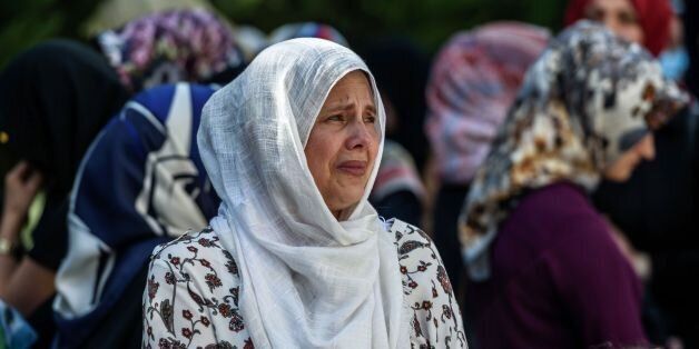 Relatives of suicide attack victim Mohammad Eymen Demirci mourn on June 29, 2016 in Istanbul during his funeral a day after a suicide bombing and gun attack targeted Istanbul's Ataturk airport, killing 41 people. Turkey pointed the finger of blame at Islamic State jihadists on June 29 after suicide bombers armed with automatic rifles attacked Istanbul's main international airport, killing 41 people, including foreigners. / AFP / OZAN KOSE (Photo credit should read OZAN KOSE/AFP/Getty Images)